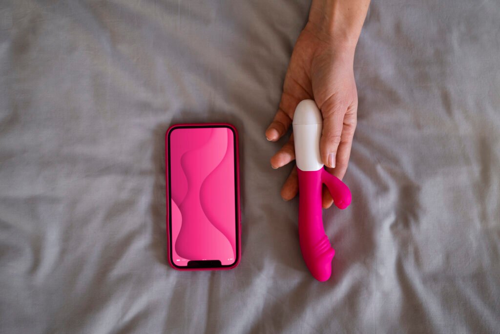 top-view-woman-with-smartphone-vibrator